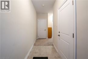 Cambridge townhouse for rent - A hallway with a door on the right and a mat on the floor.