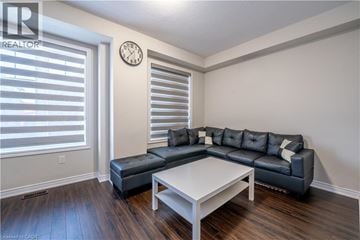 Cambridge townhouse for rent - A living room with a black couch and a white coffee table.