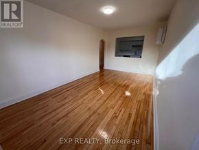 Ottawa apartment for rent - A room with wooden flooring and white walls.