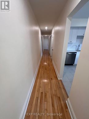 Ottawa apartment for rent - A long hallway with wood flooring and white walls.