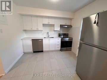Ottawa apartment for rent - A kitchen with white cabinets and a stainless steel refrigerator.