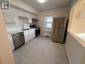 Ottawa apartment for rent - A kitchen with white cabinets and a window.