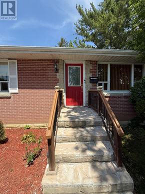 Belleville (Belleville Ward) apartment for rent - A red brick house with a wooden front door and steps leading up to it.