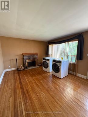Belleville (Belleville Ward) apartment for rent - A room with a fireplace and two washing machines.