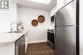 Hamilton (Stoney Creek) condo for rent - A kitchen with a refrigerator, sink, and microwave.
