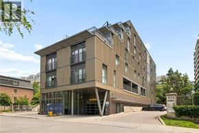 Kitchener condo for rent - A modern building with a brown facade and glass windows.