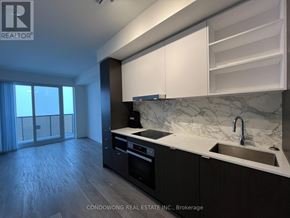 Toronto (Waterfront Communities) condo for rent - A kitchen with a sink, stove, and cabinets.