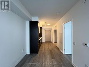 Toronto (Waterfront Communities) condo for rent - A hallway with a black door on the left and a white door on the right.