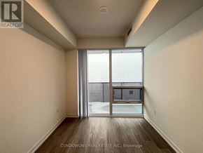 Toronto (Waterfront Communities) condo for rent - A room with a sliding glass door leading to a balcony.