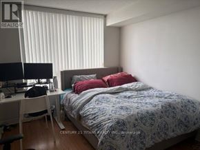 Toronto (Agincourt North) condo for rent - A bedroom with a bed, desk, and window with blinds.