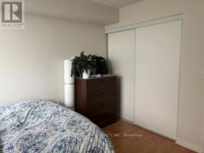 Toronto (Agincourt North) condo for rent - A bedroom with a bed, dresser, and a plant.