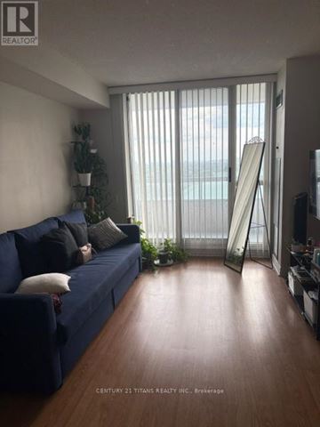 Toronto (Agincourt North) condo for rent - A living room with a blue couch and a wooden floor.