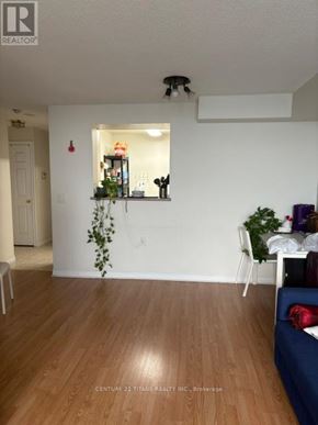 Toronto (Agincourt North) condo for rent - A living room with a couch and a dining table.