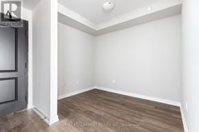 Hamilton (Stoney Creek) condo for rent - A room with a wooden floor and white walls.