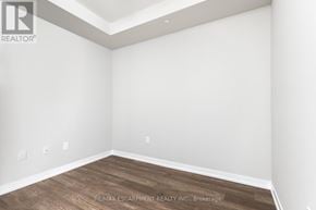 Hamilton (Stoney Creek) condo for rent - A room with a wooden floor and white walls.