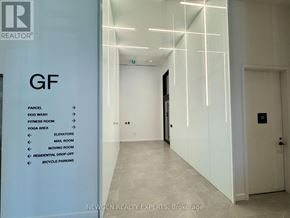 Mississauga (Cooksville) condo for rent - A hallway with a sign on the left side listing amenities.