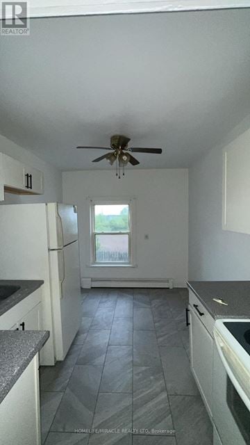 Cambridge apartment for rent - A kitchen with a fan on the ceiling and a window.