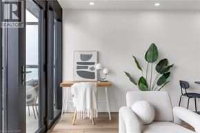 Hamilton apartment for rent - A modern living room with a white couch and a large leafy plant.