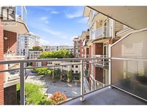 Vancouver apartment for rent - A balcony overlooks a courtyard with a glass railing.