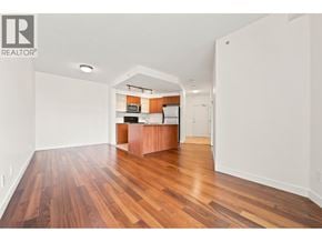 Vancouver apartment for rent - A room with wooden floors and a kitchenette area.
