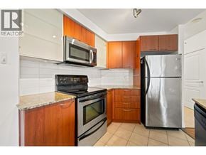 Vancouver apartment for rent - A kitchen with a stove, oven, microwave, and refrigerator.