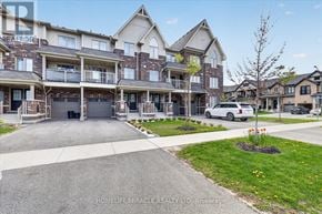 Whitby (Rolling Acres) townhouse for rent - A white car is parked in front of a building with a sign that says "HOMELIFE MIRACLE REALTY LTD Brokerage".