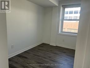 Oshawa (Central) apartment for rent - A room with a window and wooden flooring.