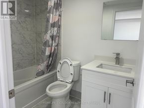 Oshawa (Central) apartment for rent - A bathroom with a toilet, sink, and shower.