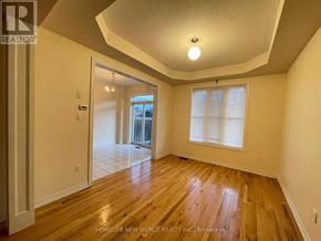 Markham (Cathedraltown) apartment for rent - A room with wooden floors and a ceiling light.