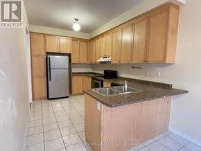 Markham (Cathedraltown) apartment for rent - A kitchen with a refrigerator, sink, and cabinets.