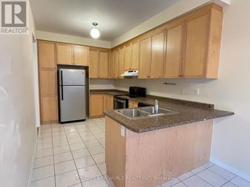 Markham (Cathedraltown) apartment for rent - A kitchen with a refrigerator, sink, and cabinets.