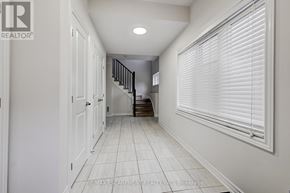 Hamilton (Waterdown) townhouse for rent - A hallway with white walls and a tiled floor.