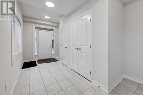 Hamilton (Waterdown) townhouse for rent - A hallway with white walls and a tiled floor.