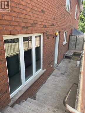 Grimsby (Grimsby East) fourplex for rent - A brick house with a window and a door.