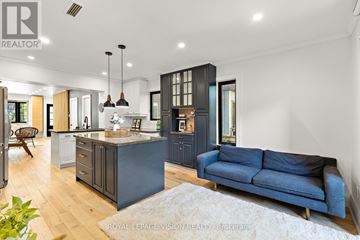 Toronto (Lawrence Park North) apartment for rent - A modern kitchen with a blue sofa in the living room.