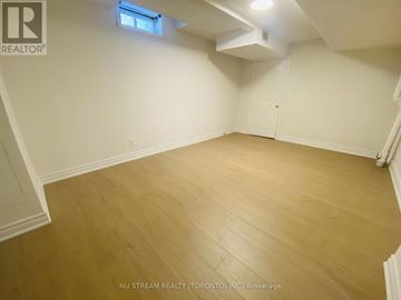 Barrie (Holly) apartment for rent - A room with wooden flooring and white walls.