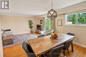 Mississauga (Cooksville) apartment for rent - A dining room with a wooden table and chairs.