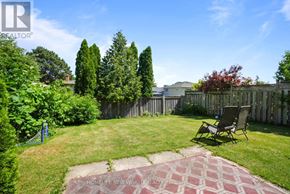 Mississauga (Cooksville) apartment for rent - A backyard with a lawn, a bench, and a brick pathway.