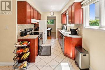 Mississauga (Cooksville) apartment for rent - A kitchen with brown cabinets and a white refrigerator.
