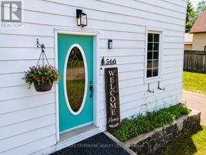 Pembroke apartment for rent - A white house with a blue door and a sign that says "Welcome Home".