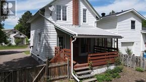 Pembroke apartment for rent - A white house with a brown front porch.