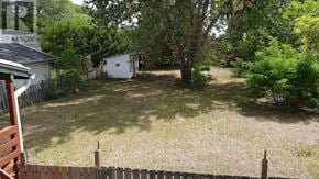 Pembroke apartment for rent - A yard with a white shed and a fence.