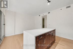 Ottawa condo for rent - A white kitchen island with wooden drawers in a white room.