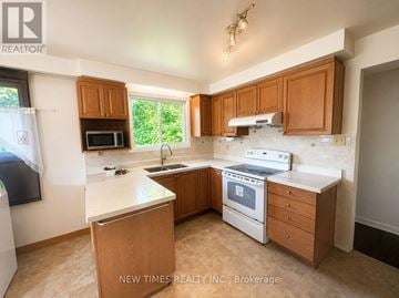 Toronto (Bayview Woods-Steeles) apartment for rent - A kitchen with a white counter top and wooden cabinets.