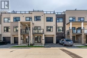 Burlington (Lasalle) townhouse for rent - A modern apartment building with a car parked in front.