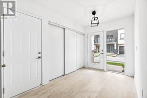 Burlington (Lasalle) townhouse for rent - A white interior room with a sliding door and a balcony outside.