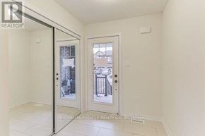 Hamilton (Stoney Creek) townhouse for rent - A room with a sliding door leading to a balcony.