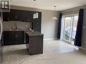 Niagara Falls (Forestview) townhouse for rent - A kitchen with black cabinets and a sink.