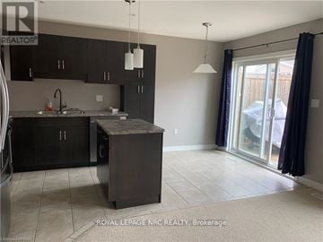 Niagara Falls (Forestview) townhouse for rent - A kitchen with black cabinets and a sink.