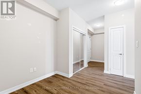 Hamilton (Waterdown) condo for rent - A white door is on the right side of the room.